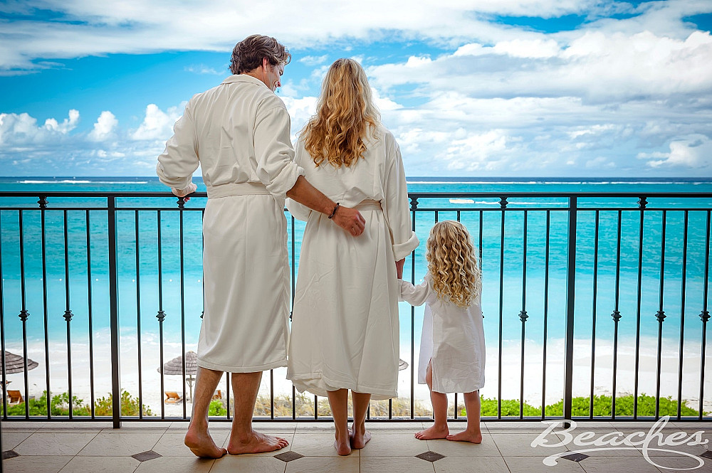 beaches-turks-caicos-family-on-balcony-italian-village-oceanfront